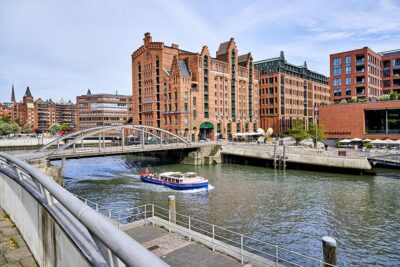 Hamburg Boat sails over canal in the Hafencity with Speicherstadt 